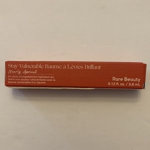 Rare Beauty Stay Vulnerable Nearly Apricot Glossy Lip Balm.
